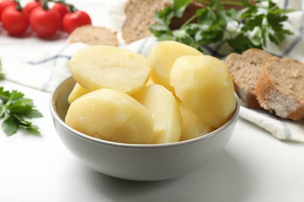 Young,Boiled,Potatoes,In,Bowl,On,White,Table,,Closeup