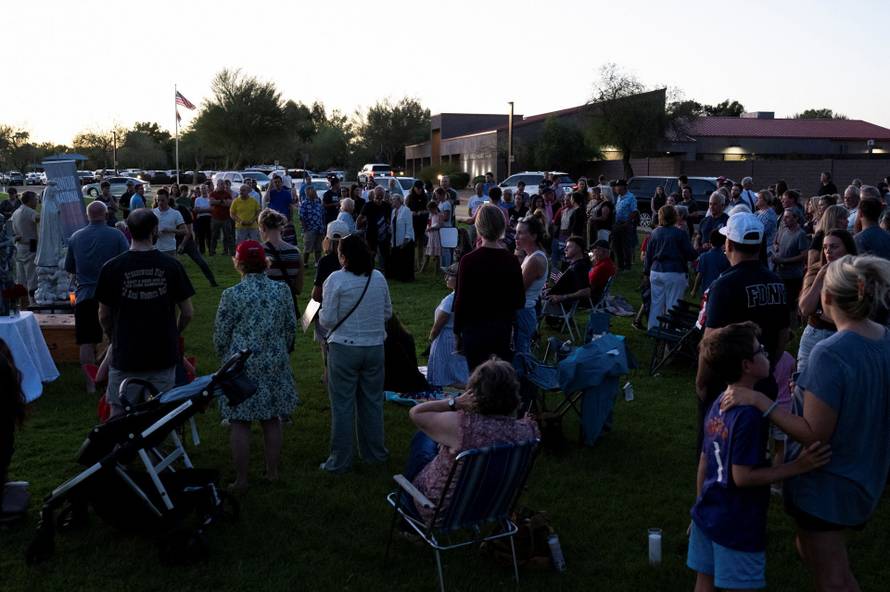 Catholics from across the Phoenix area gather to pray for Charlie Kirk, who was shot and killed in Utah, at Desert Horizon Park in Scottsdale