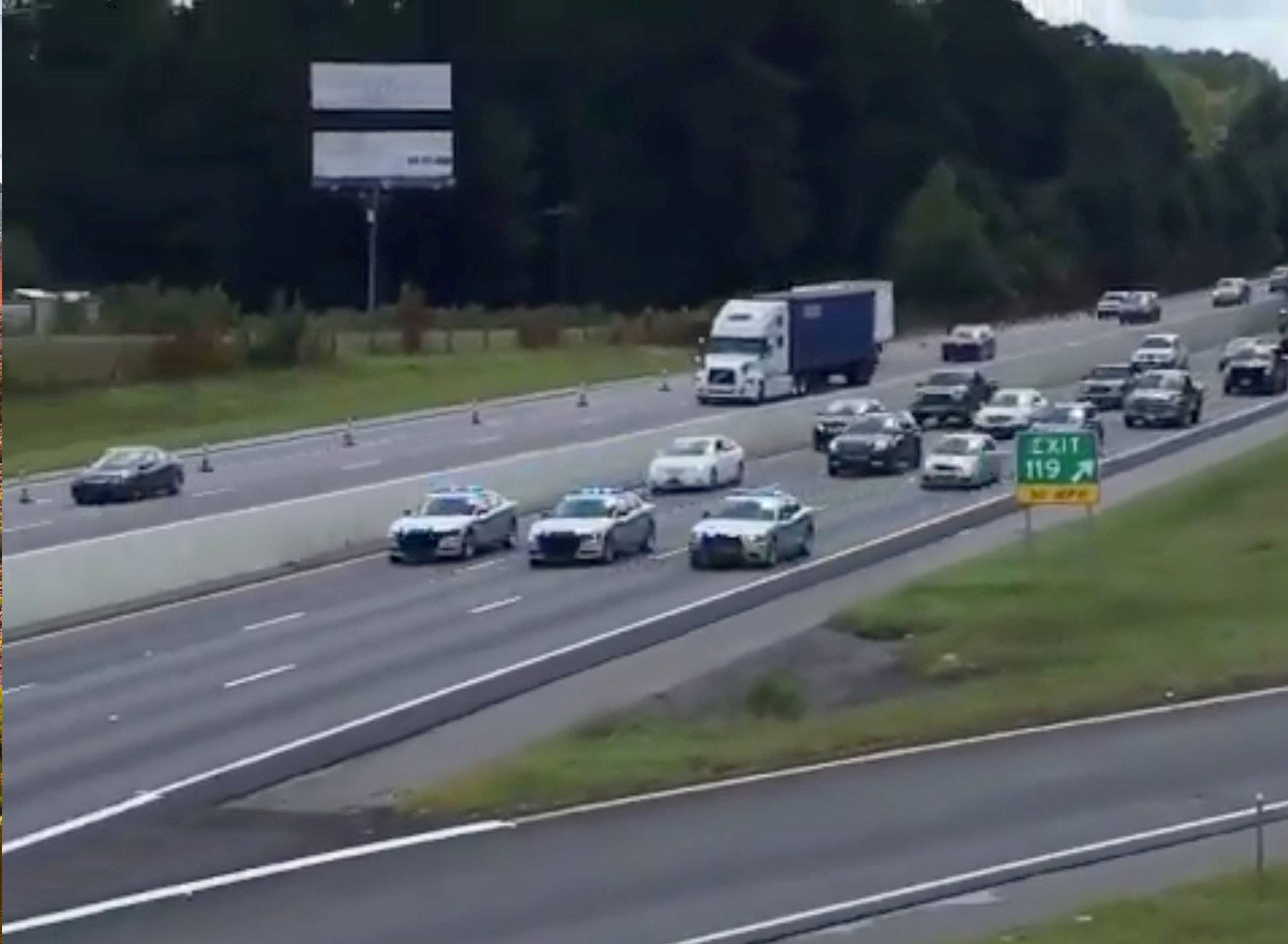 South Carolina Highway Patrol cars escort a line of vehicles as they lead traffic from Charleston to Columbia, as residents prepare ahead of Hurricane Florence's descent