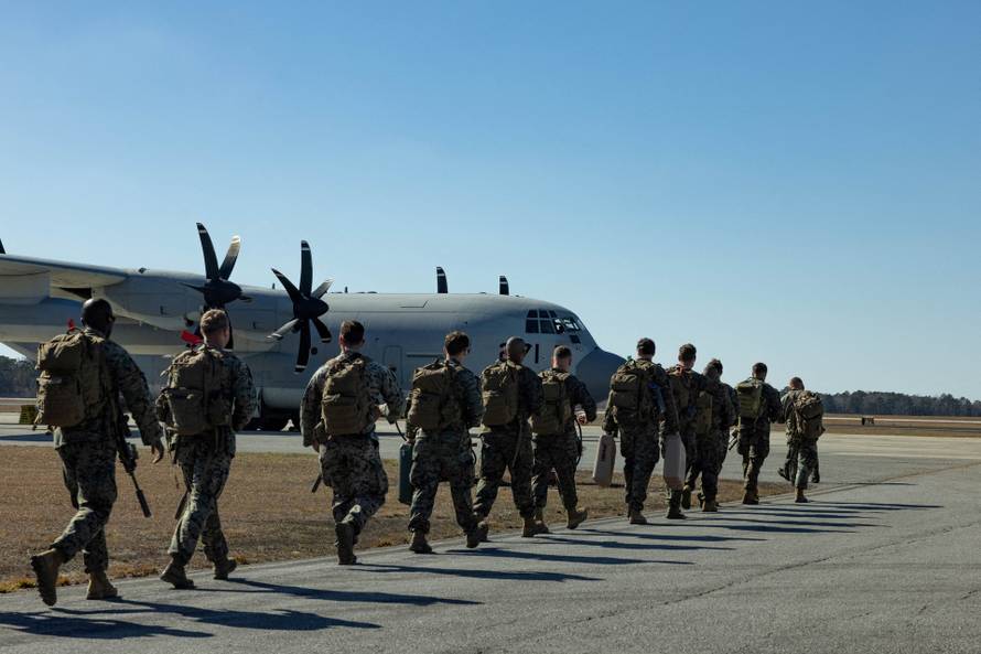 FILE PHOTO: U.S. Marines depart en route to support migrant holding operations at Guantanamo Bay, in Jacksonville