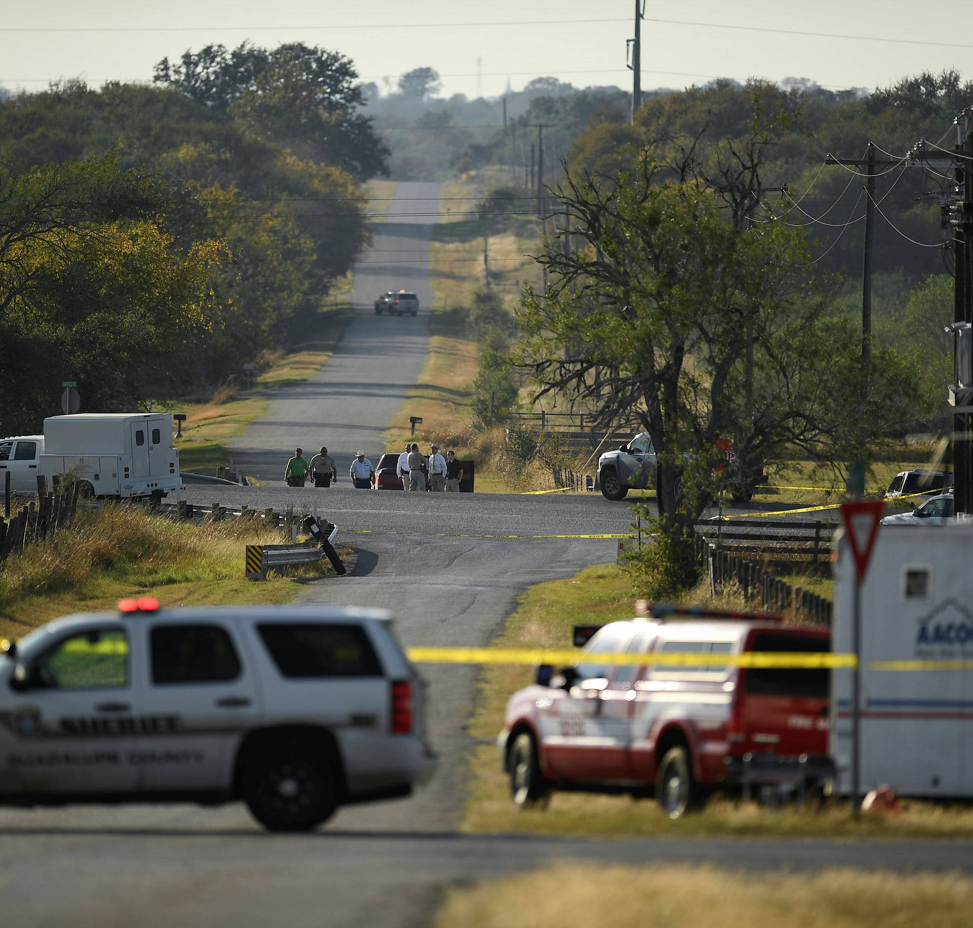 Law enforcement set up a cordon along an intersection in the aftermath of a mass shooting in Sutherland Springs, Texas