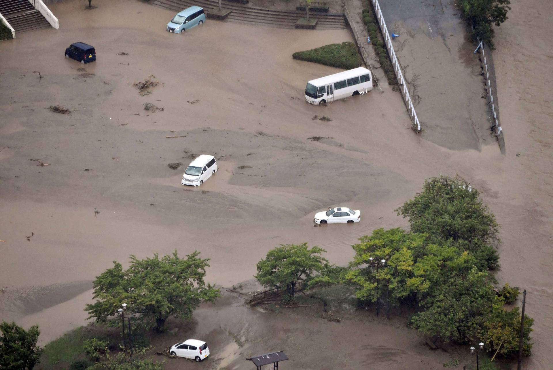 An aerial view shows submerged cars caused by a torrential rain at the parking space of the city government office in Wajima