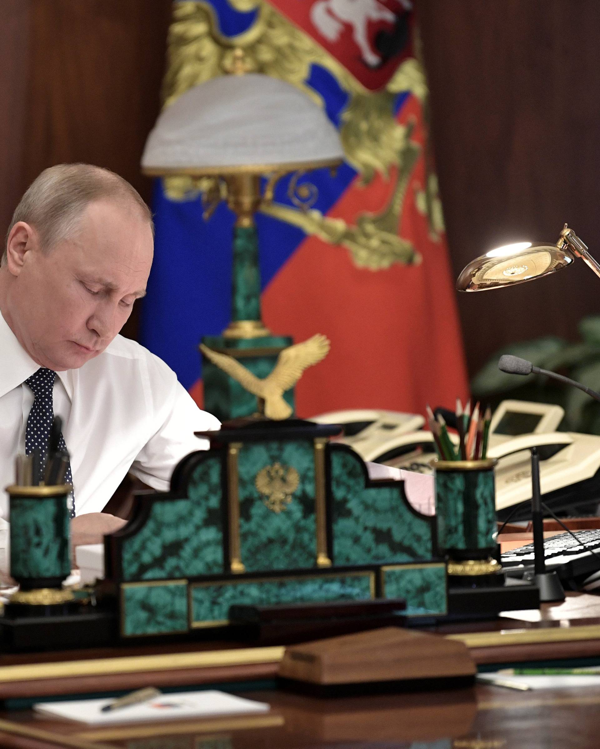 Russian President Putin works in his cabinet before an inauguration ceremony at the Kremlin in Moscow