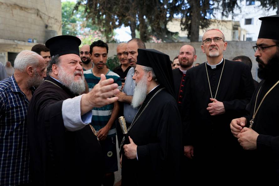 Members of the clergy visit the Greek Orthodox Saint Porphyrius Church, in Gaza City