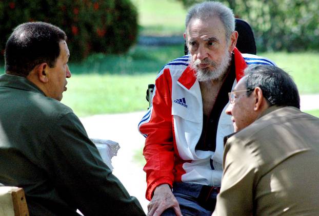 File photo of former Cuban President Fidel Castro listening during a meeting with his brother Cuban President Raul Castro and Venezuela