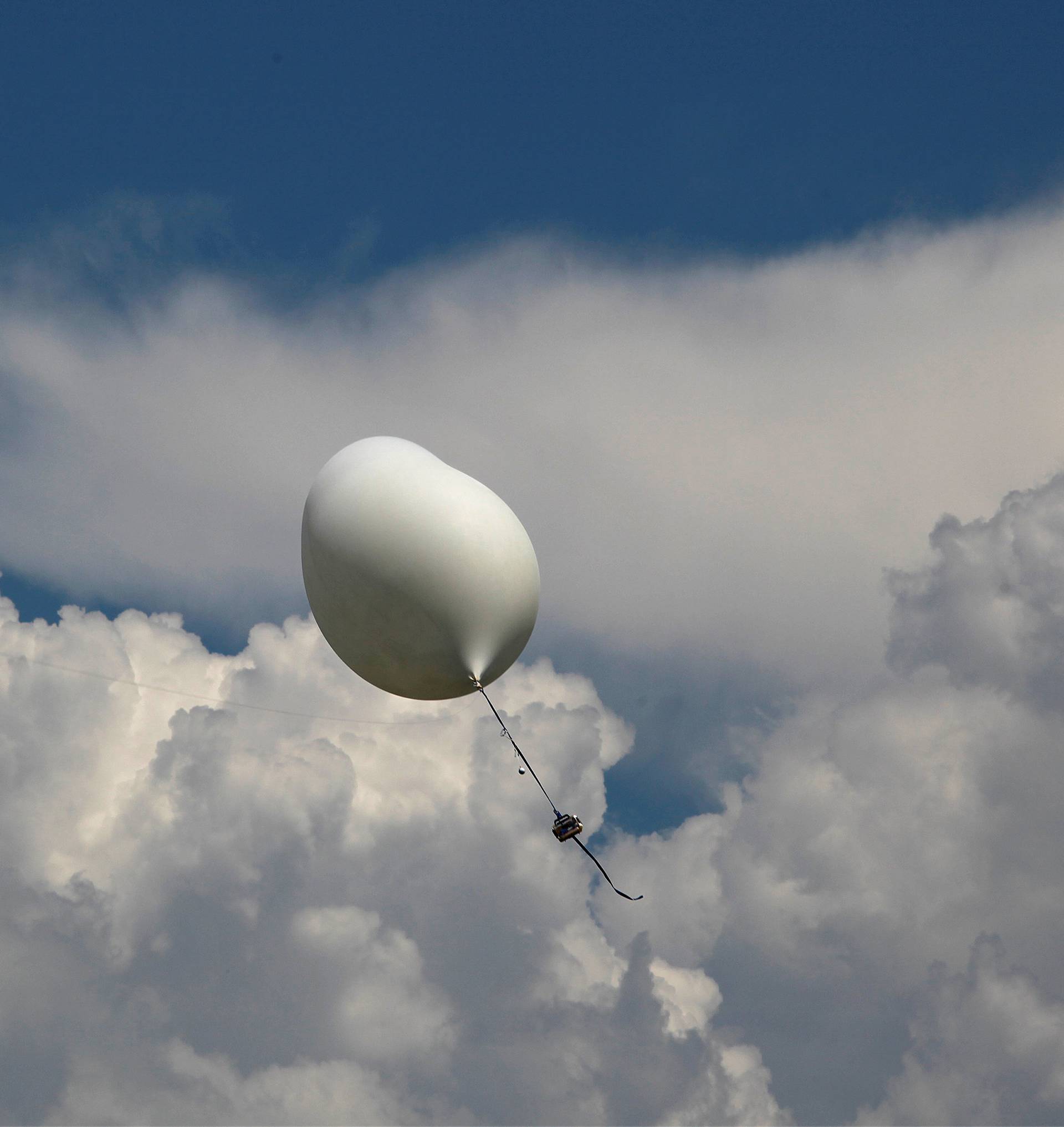 A balloon carries cameras and other equipment that will be used to monitor the coming solar eclipse during a test launch on board a US Coast Guard response boat at sea near Charleston