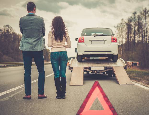 Couple,Near,Tow-truck,Picking,Up,Broken,Car