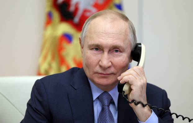 Russia's President Putin speaks on phone at his residence outside Moscow