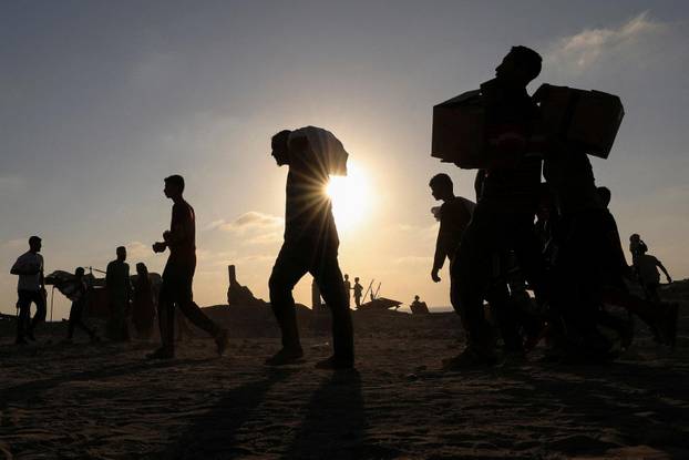 FILE PHOTO: Palestinians receive aid supplies in Beit Lahia