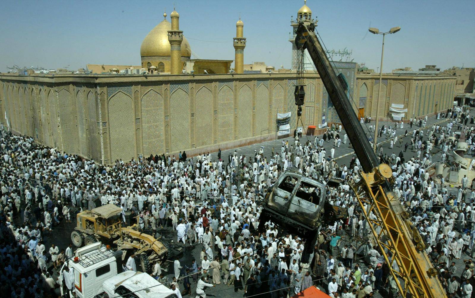 FILE PHOTO: Burned-out car removed from front of main mosque in Najaf