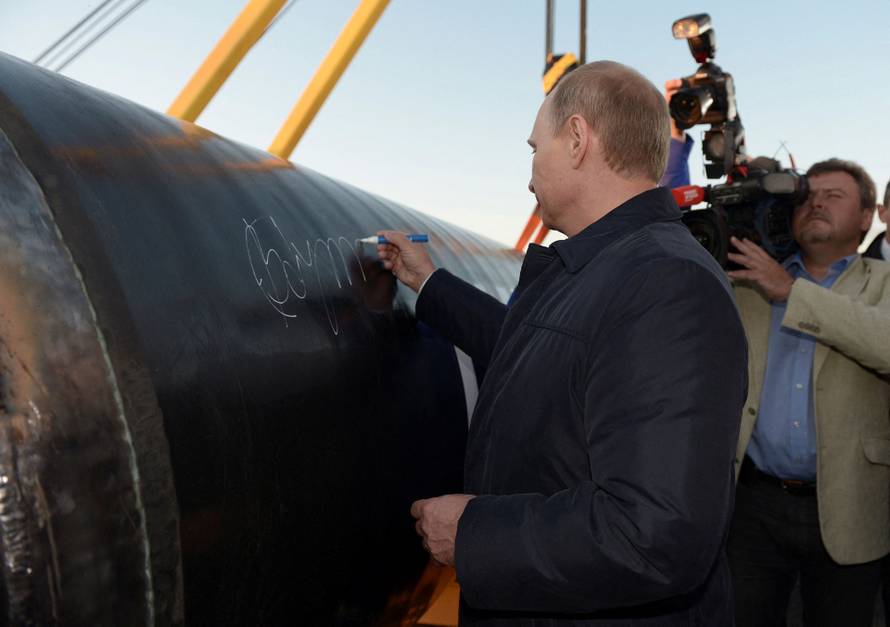 FILE PHOTO: Russia's President Putin signs on the first segment of pipeline during a ceremony marking the start of construction of "Power of Siberia" pipeline at the village of Us Khatyn