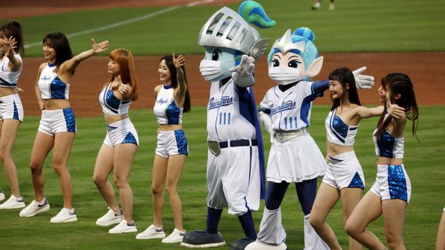 Mascots of a baseball team dance while wearing face masks at the first professional league game that allow audience since the outbreak of the coronavirus disease (COVID-19) in Taipei