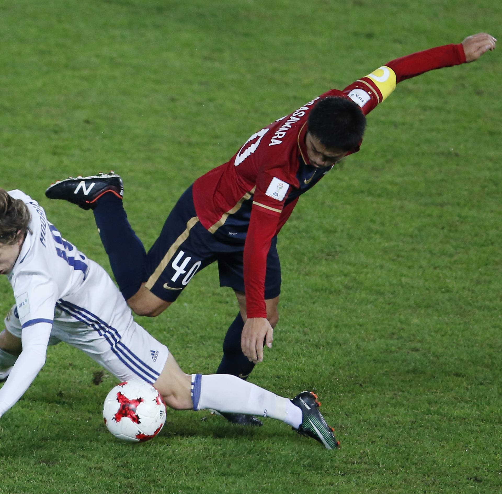 Real Madrid's Luka Modric in action against Kashima Antlers Mitsuo Ogasawara