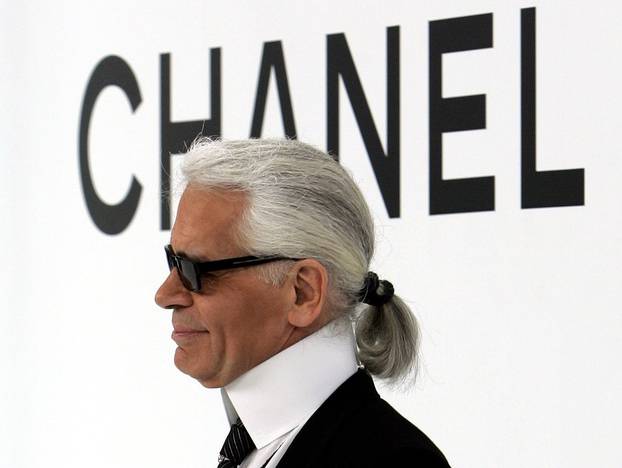 FILE PHOTO -  German designer Karl Lagerfeld appears on the catwalk after his Autumn/Winter 2004/2005 high fashion collection for the Chanel fashion house in Paris
