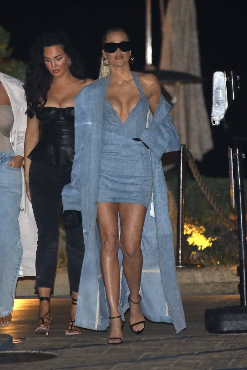 *EXCLUSIVE* Khloe Kardashian highlights her ample cleavage in the low-cut denim dress!