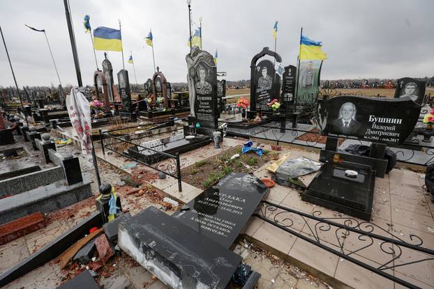Graves of killed Ukrainian soldiers damaged by shelling are seen at a cemetery in Chernihiv