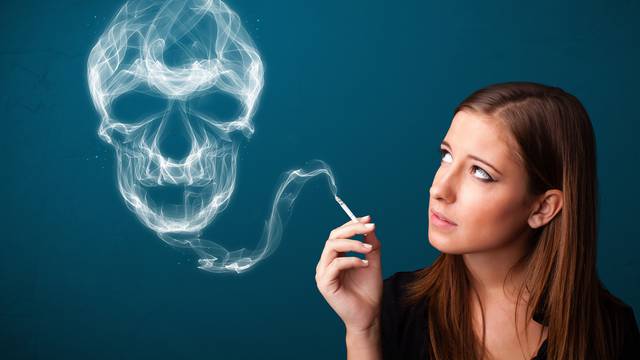 Young woman smoking dangerous cigarette with toxic skull smoke