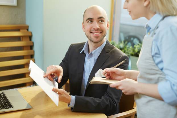 Businessman ordering lunch in cafe