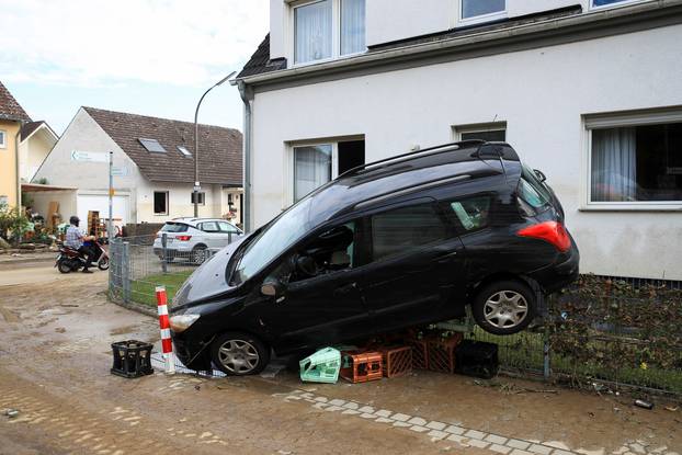 A car leaning against the fence is seen on a flood-affected area in Bad Neuenahr-Ahrweiler