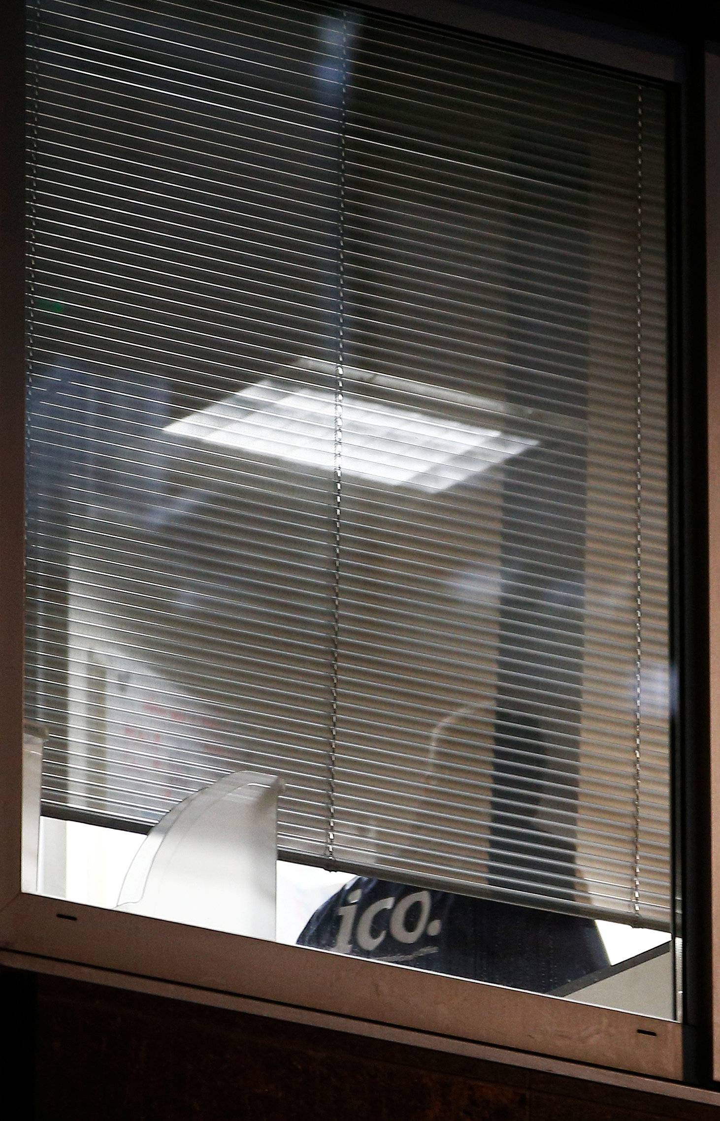 An investigator from Britain's Information Commissioners Office, is seen inside the building which houses the offices of Cambridge Analytica as investigators in London