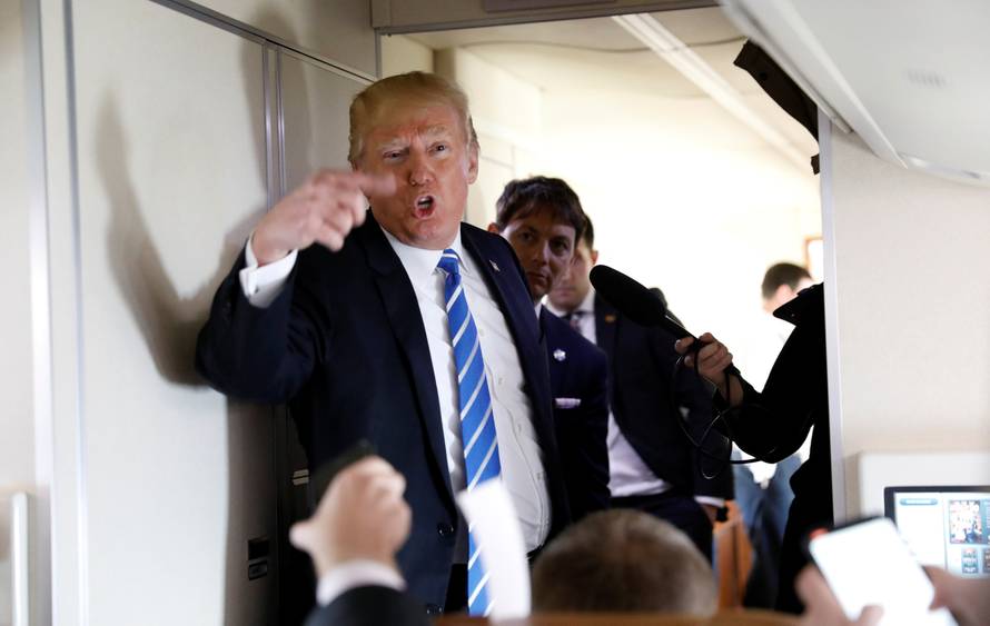 U.S. President Donald Trump speaks aboard Air Force One