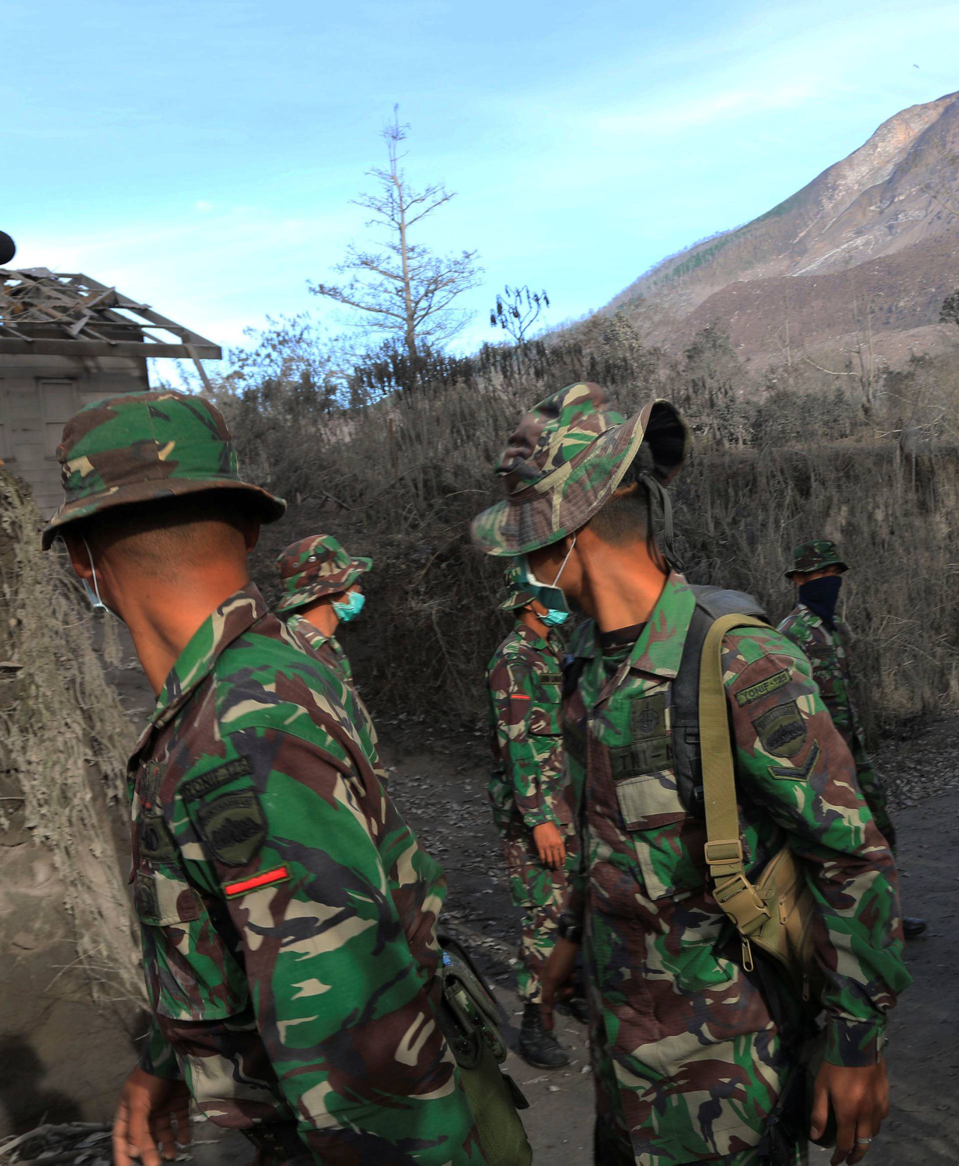 Indonesian soldiers search an area following a deadly eruption of Mount Sinabung volcano in Gamber Village, North Sumatra, Indonesia 