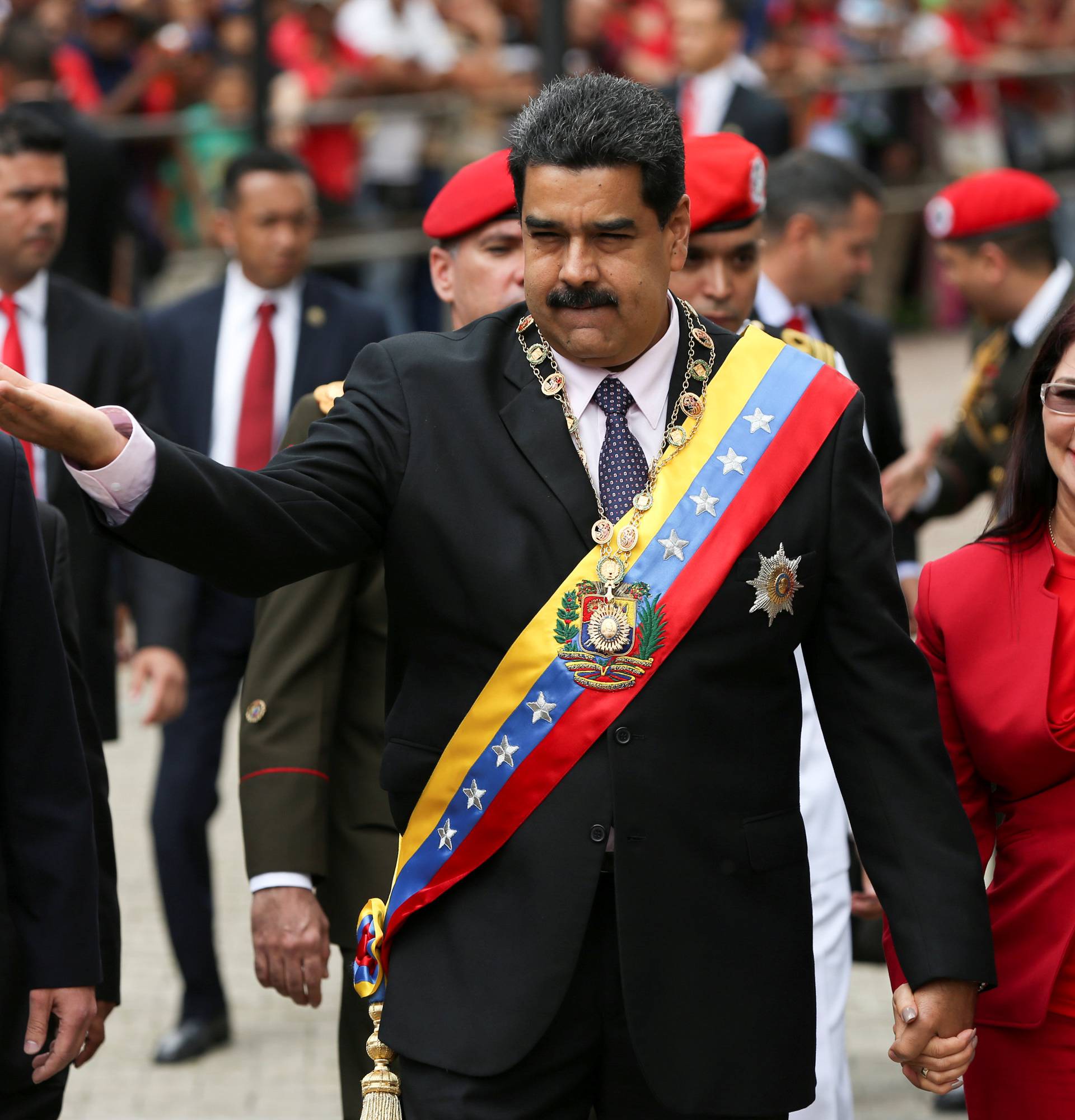 Venezuela's President Maduro greets supporters as he arrives with his wife, Cilia Flores, to give his year-in-review speech at the Supreme Court in Caracas