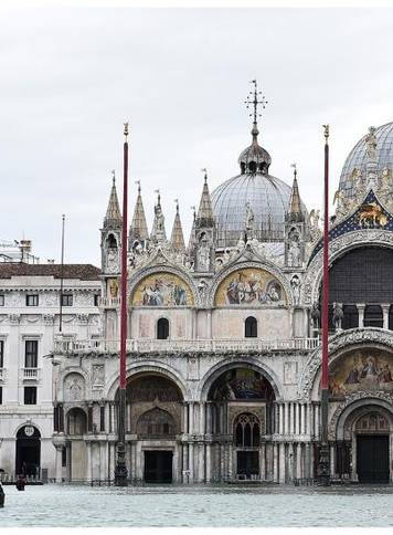 A combination picture shows St. Mark's Basilica before and after floods in Venice