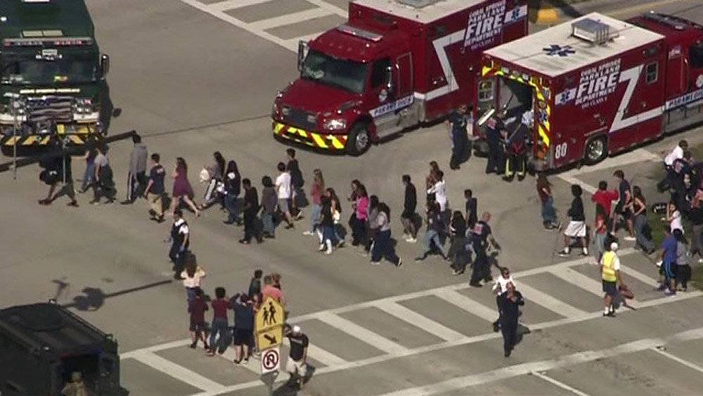 Students are evacuated from Marjory Stoneman Douglas High School during a shooting incident in Parkland