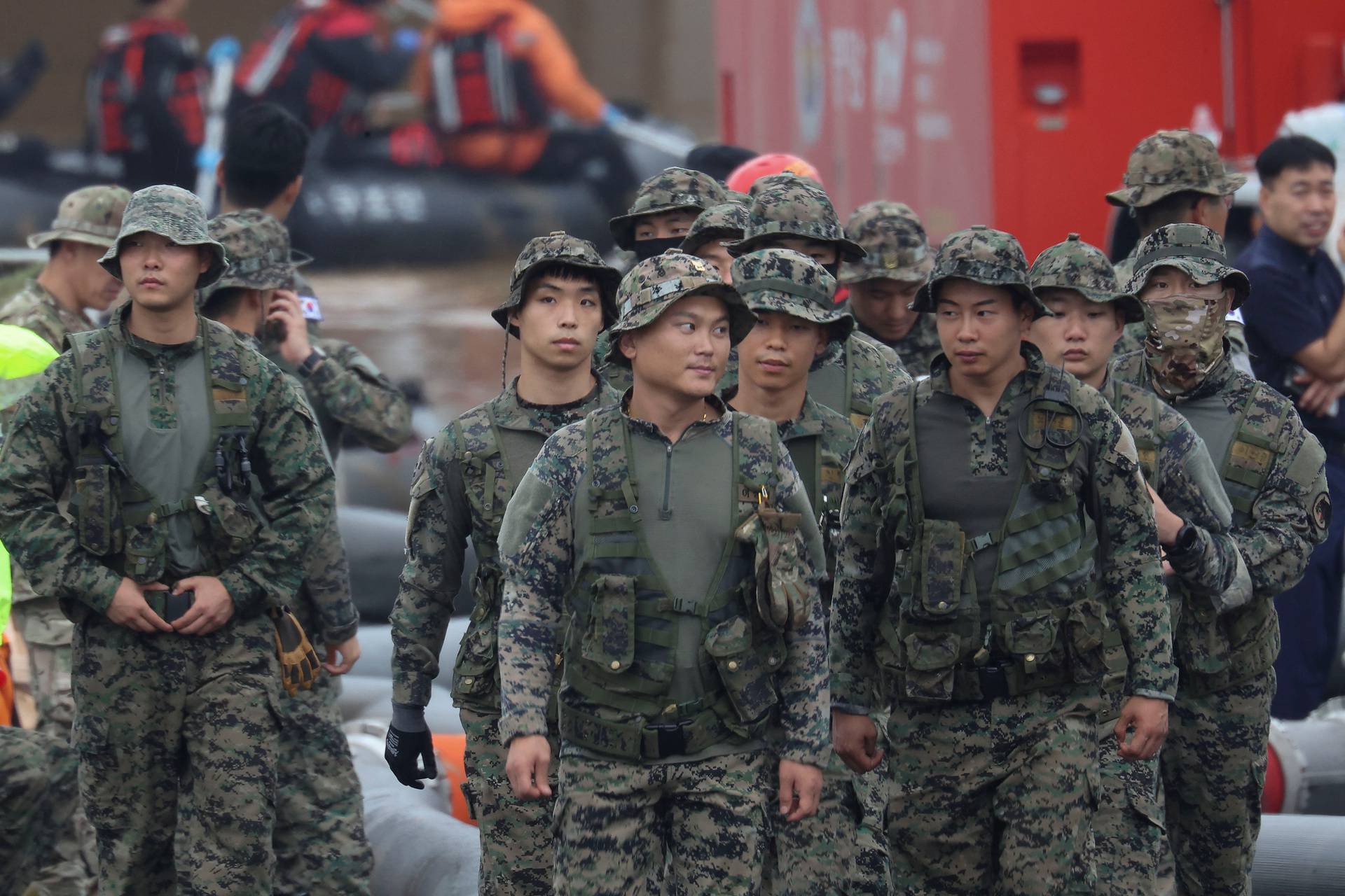 Rescue workers take part in a search and rescue operation at an underpass that has been submerged by an flooded river caused by torrential rain in Cheongju