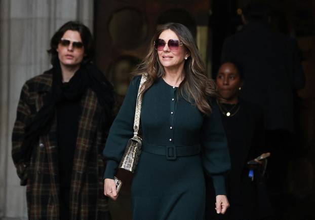 Actor Liz Hurley with her son Damian Hurley walk outside the High Court in London