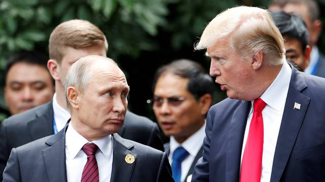 FILE PHOTO: U.S. President Donald Trump and Russia's President Vladimir Putin talk during the family photo session at the APEC Summit in Danang, Vietnam
