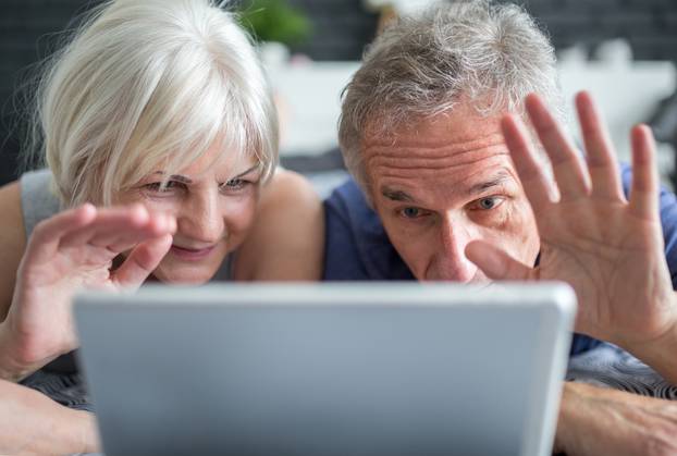 Senior marriage having video conversation on tablet