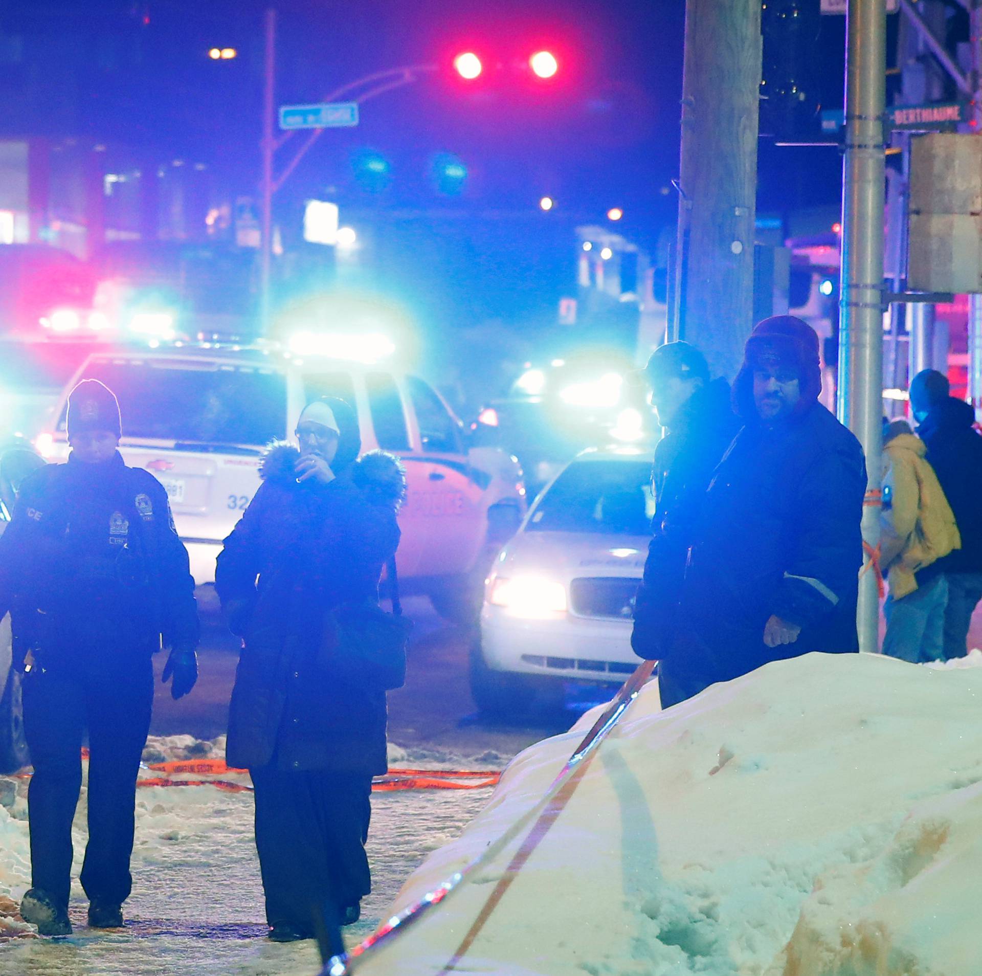 Police officers are seen near a mosque after a shooting in Quebec City
