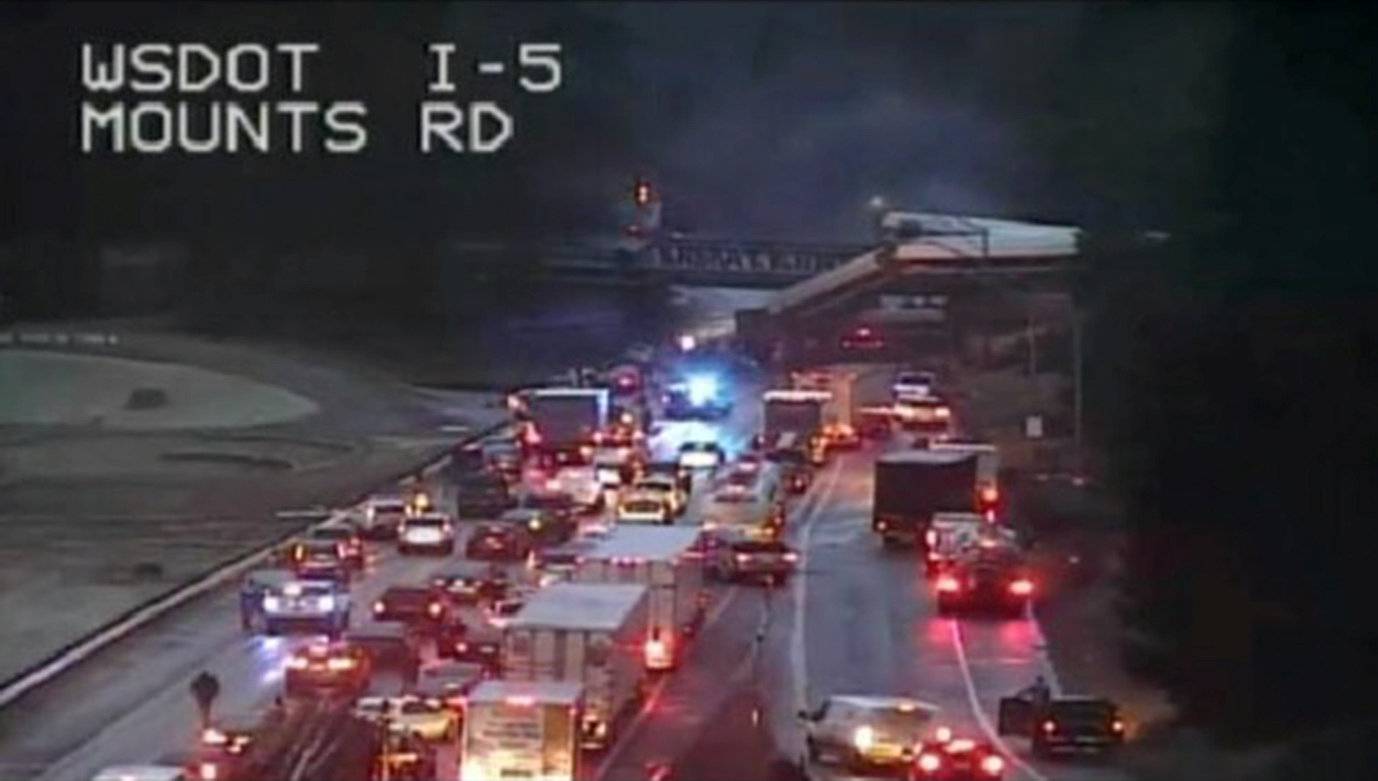 A still image from a video camera shows an Amtrak train that derailed on a bridge over a highway in Pierce County