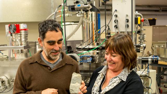 Nutman of the University of Woollongong and Bennet of the Australian National University hold a specimen of 3.7 billion-year-old fossils found in Greenland in Canberra