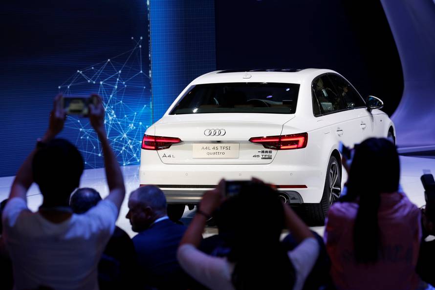 Visitors take picture of Audi A4L 45 TFSI quattro at its launching ceremony during the Auto China 2016 auto show in Beijing