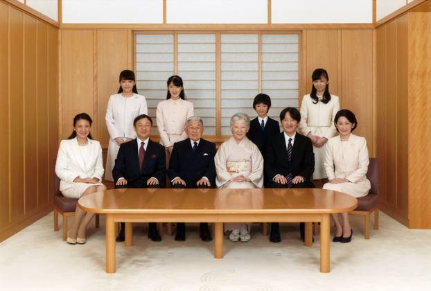 FILE PHOTO - Japanese Emperor Akihito and Empress Michiko smile with their family members during a photo session for the New Year at the Imperial Palace in Tokyo