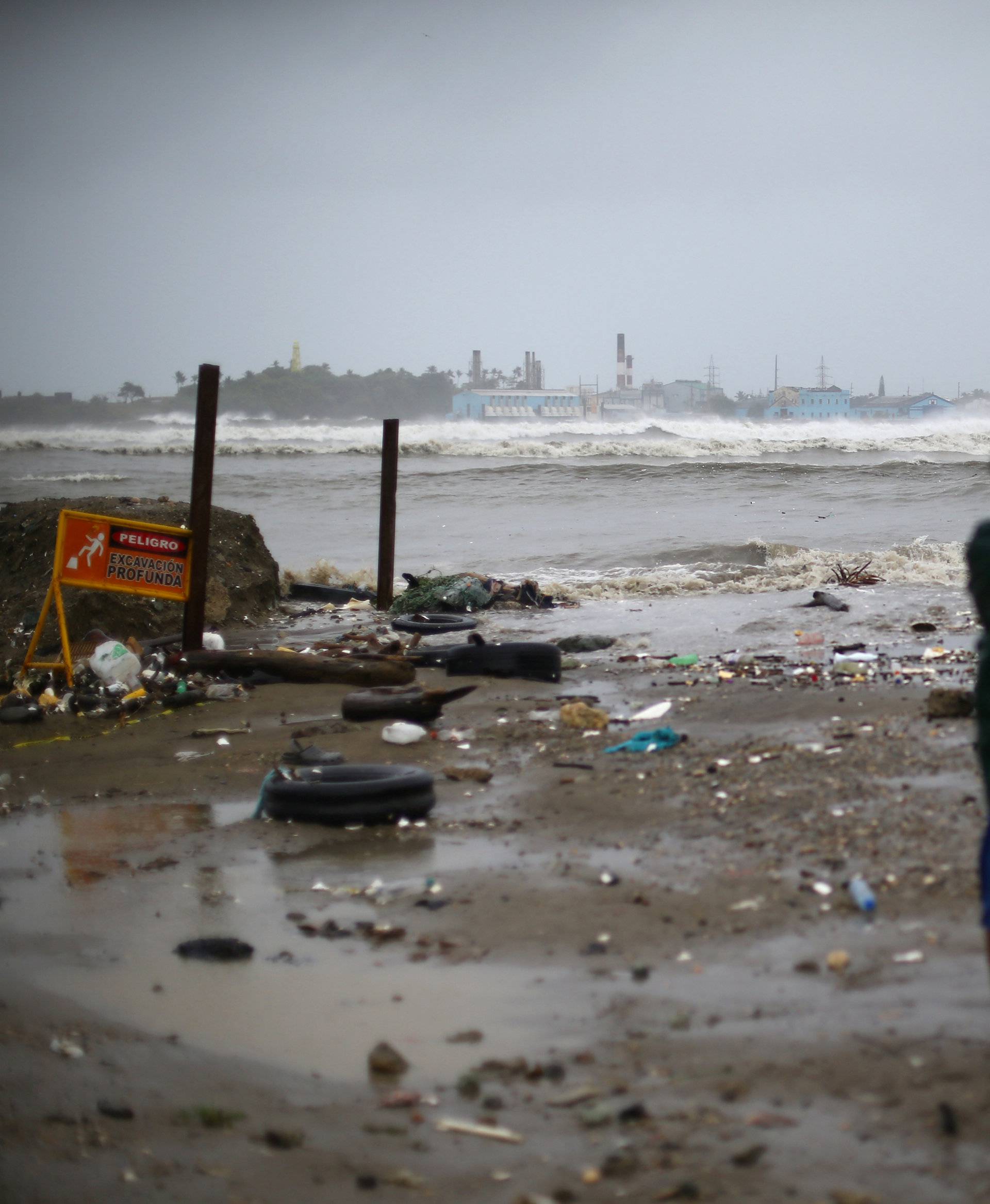 People look out to the sea as Hurricane Irma moves off the northern coast of the Dominican Republic