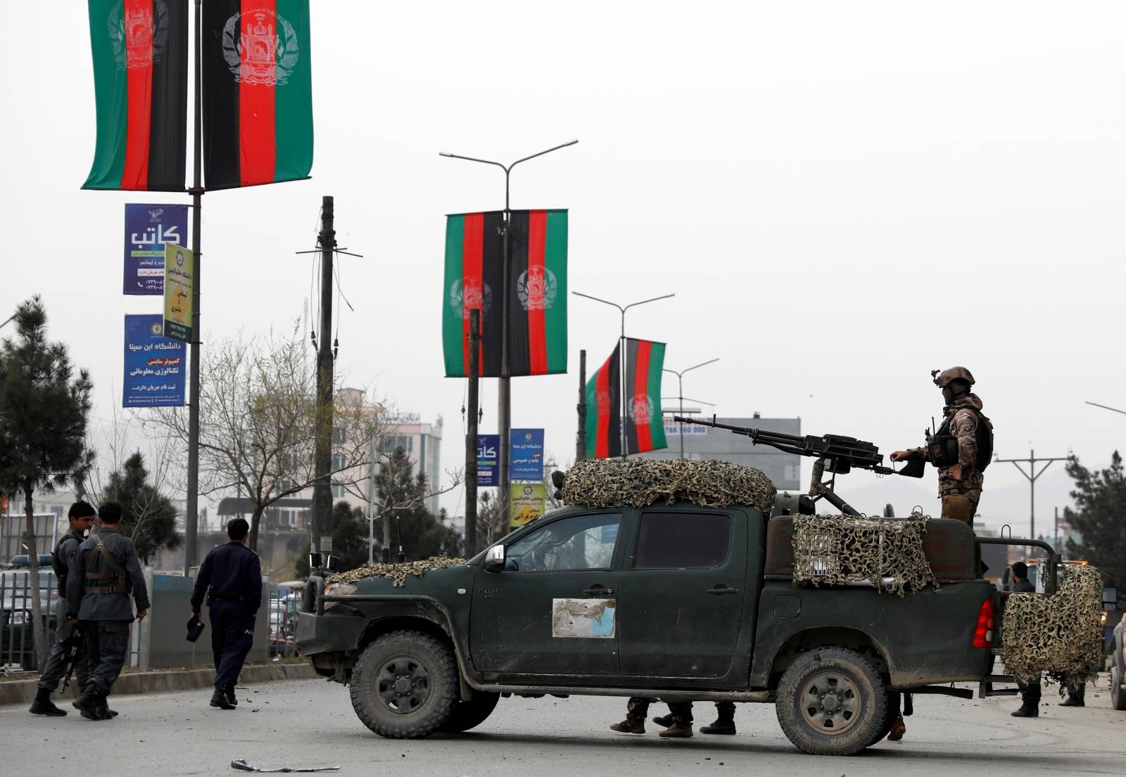 Afghan security forces inspect the site of a blast in Kabul