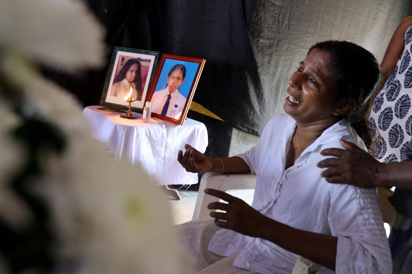 The mother of Shaini, 13, who died as bomb blasts ripped through churches and luxury hotels on Easter, mourns at her wake, in Negombo