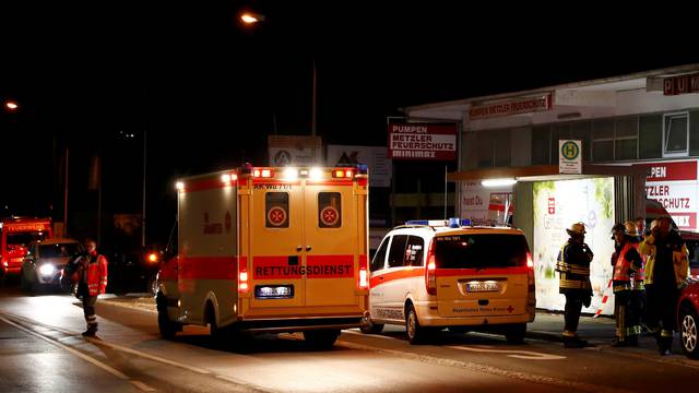 German emergency services workers work in the area where a man with an axe attacked passengers on a train near Wuerzburg