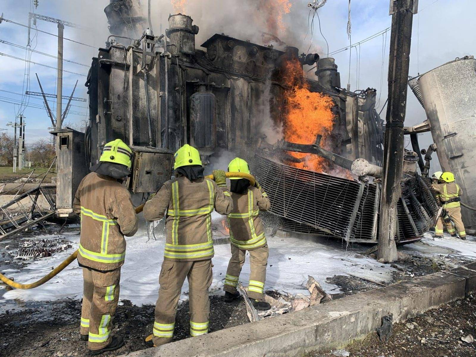 Firefighters work to put out a fire at energy infrastructure facilities damaged by a Russian missile strike in Rivne region