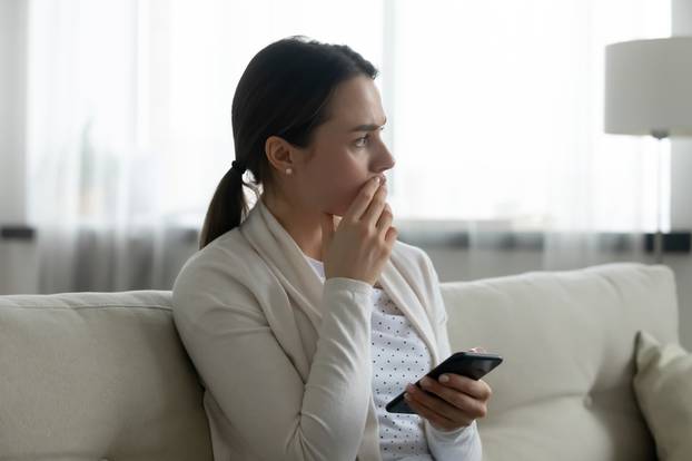 Pensive,Stressed,Young,Caucasian,Woman,Sit,On,Sofa,At,Home