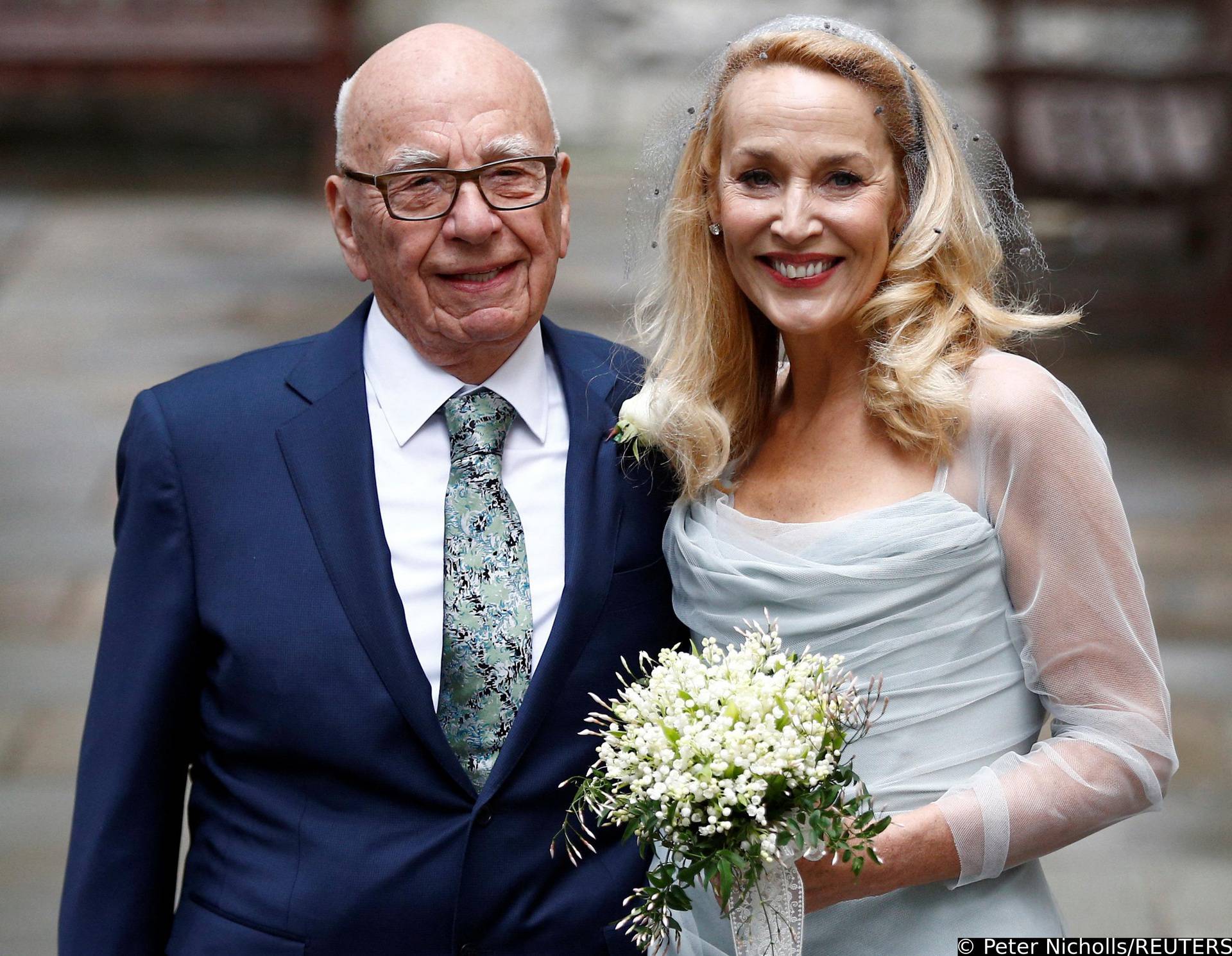 FILE PHOTO: Media Mogul Rupert Murdoch and former supermodel Jerry Hall pose for a photograph outside St Bride's church following a service to celebrate their wedding which took place on Friday, in London