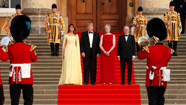 British Prime Minister Theresa May and her husband Philip stand together with U.S. President Donald Trump and First Lady Melania Trump at the entrance to Blenheim Palace near Oxford