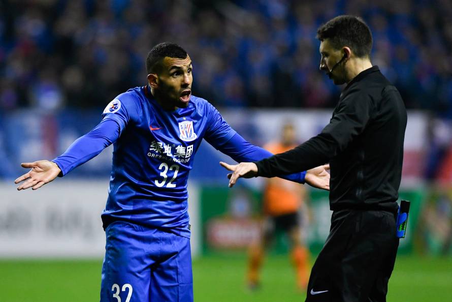 Shanghai Shenhua's Carlos Tevez reacts to a referee during the AFC Champions League 2017 play-off match between Shanghai Shenhua and Brisbane Roar in Shanghai