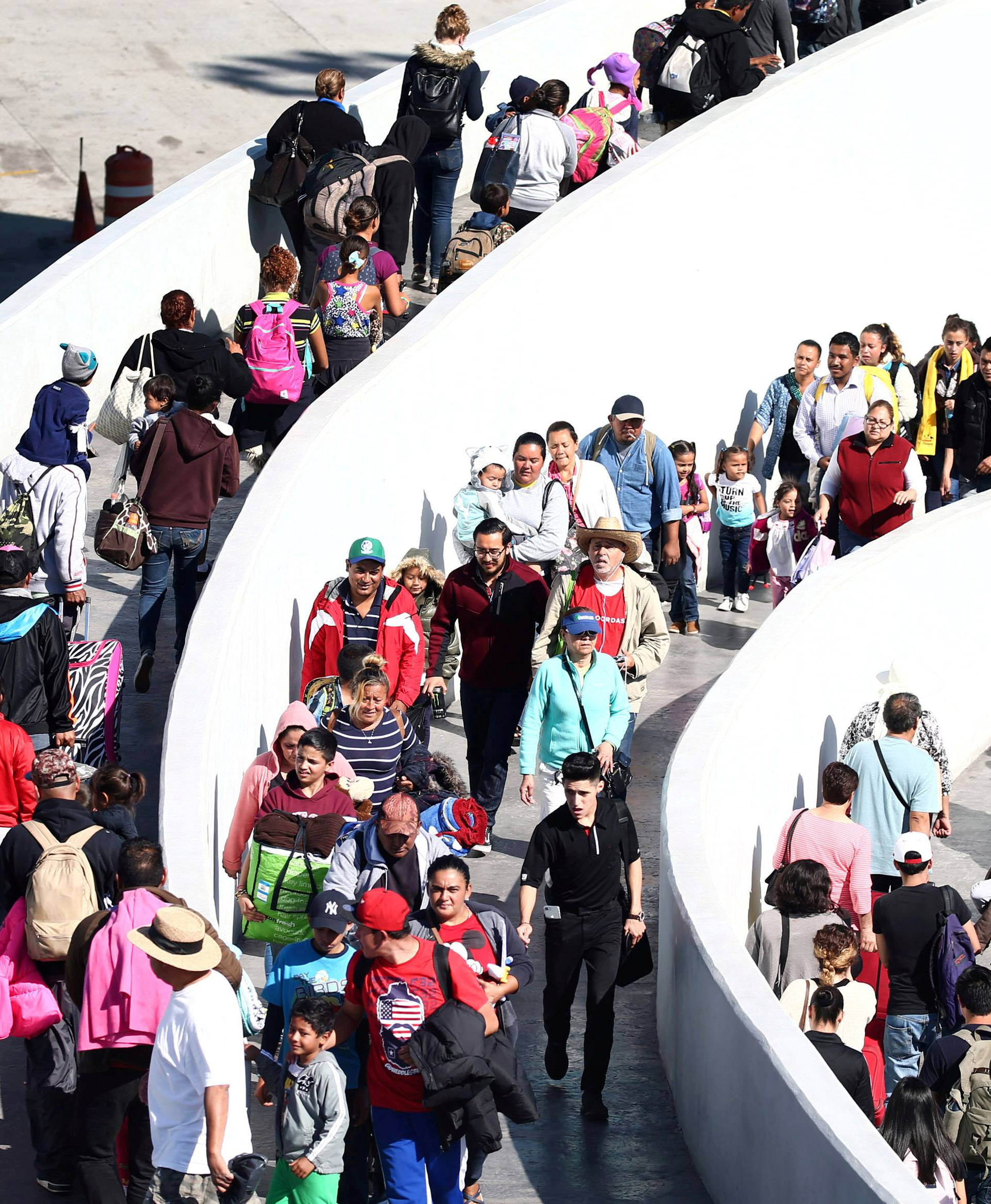 FILE PHOTO: Members of a caravan of migrants from Central America enter the United States border and customs facility where they are expected to apply for asylum in Tijuana