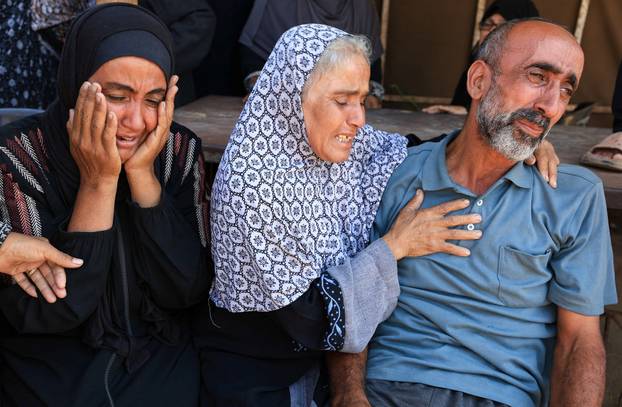 Mourners attend the funeral of Palestinians killed in overnight Israeli airstrikes, in Gaza City