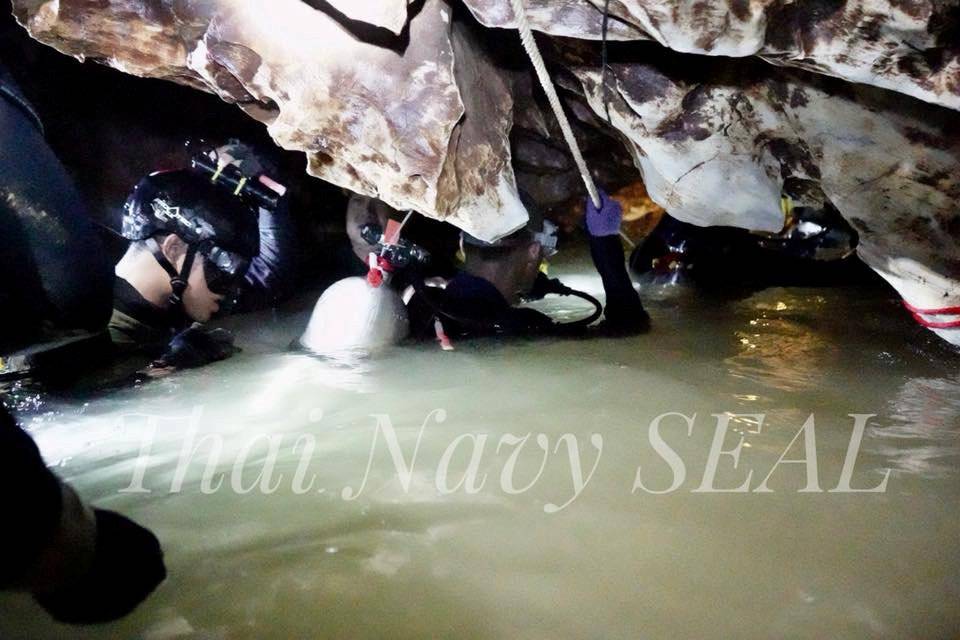 Rescue personnel work at the Tham Luang cave complex, as members of an under-16 soccer team and their coach have been found alive according to local media, in the northern province of Chiang Rai